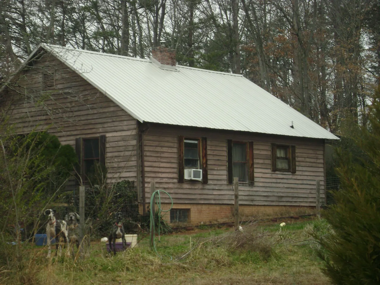 White metal roof on an old wood sided farmhouse, from a Metal Roof Installation job in Pennington
